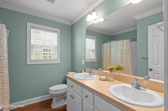 905 Sebring Dr, Winterville, NC 28590 - full bathroom with double vanity, toilet, wood finished floors, baseboards, and ornamental molding