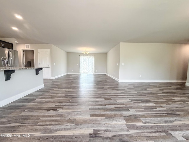 126 Vick Ave, Carthage, NC 28327 - unfurnished living room featuring a chandelier, dark wood finished floors, baseboards, and recessed lighting