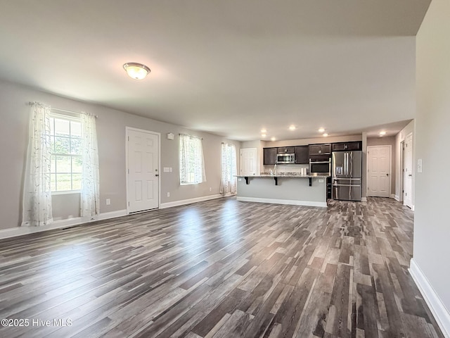 126 Vick Ave, Carthage, NC 28327 - unfurnished living room with dark wood-type flooring, recessed lighting, and baseboards
