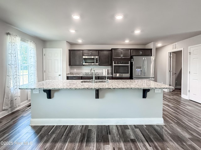 126 Vick Ave, Carthage, NC 28327 - kitchen featuring appliances with stainless steel finishes, a sink, a kitchen breakfast bar, baseboards, and recessed lighting