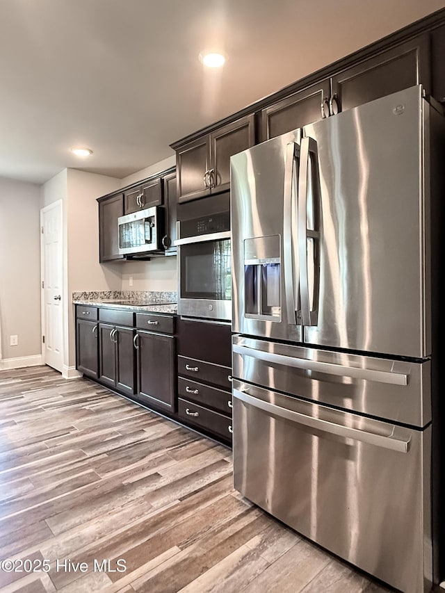 126 Vick Ave, Carthage, NC 28327 - kitchen with stainless steel appliances, light wood finished floors, baseboards, recessed lighting, and dark brown cabinets