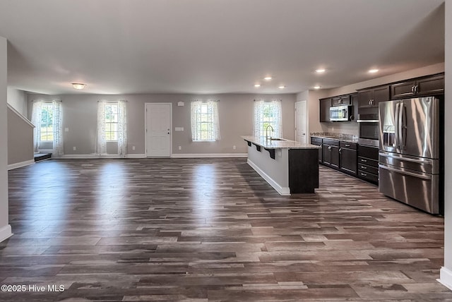 126 Vick Ave, Carthage, NC 28327 - kitchen featuring appliances with stainless steel finishes, dark wood-style floors, baseboards, a sink, and open floor plan
