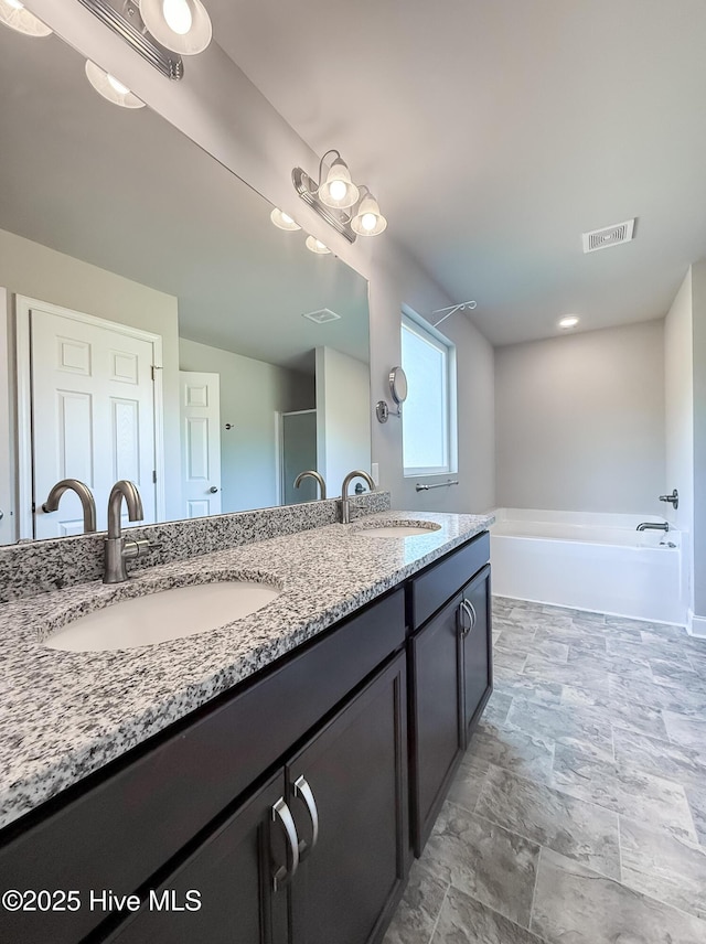 126 Vick Ave, Carthage, NC 28327 - bathroom with double vanity, a garden tub, and stone finish flooring