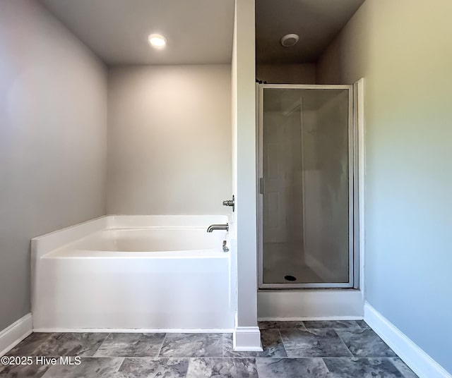 126 Vick Ave, Carthage, NC 28327 - full bathroom featuring a bath, a stall shower, and baseboards
