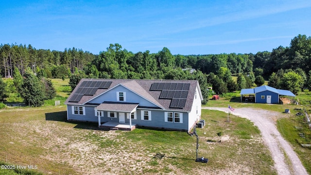 126 Vick Ave, Carthage, NC 28327 - view of front of property with driveway, a wooded view, a front lawn, and a shingled roof