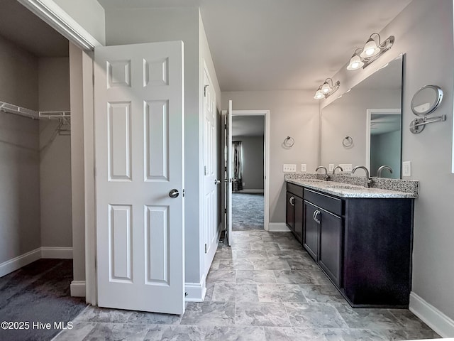 126 Vick Ave, Carthage, NC 28327 - full bath featuring baseboards, double vanity, and a walk in closet