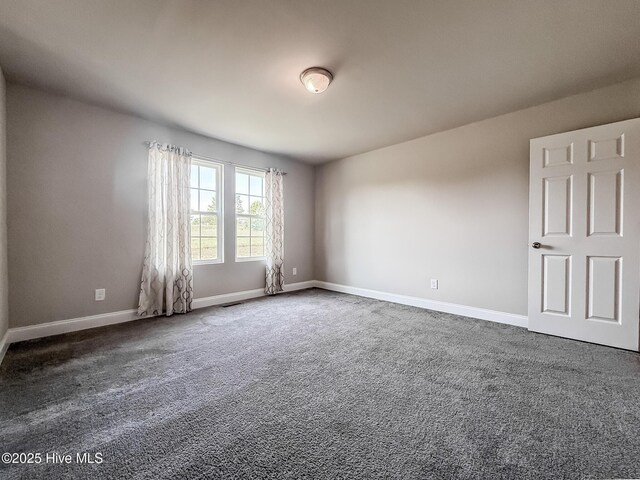 126 Vick Ave, Carthage, NC 28327 - empty room with dark carpet and baseboards