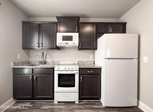 126 Vick Ave, Carthage, NC 28327 - kitchen with white appliances, baseboards, a sink, dark wood finished floors, and light stone counters