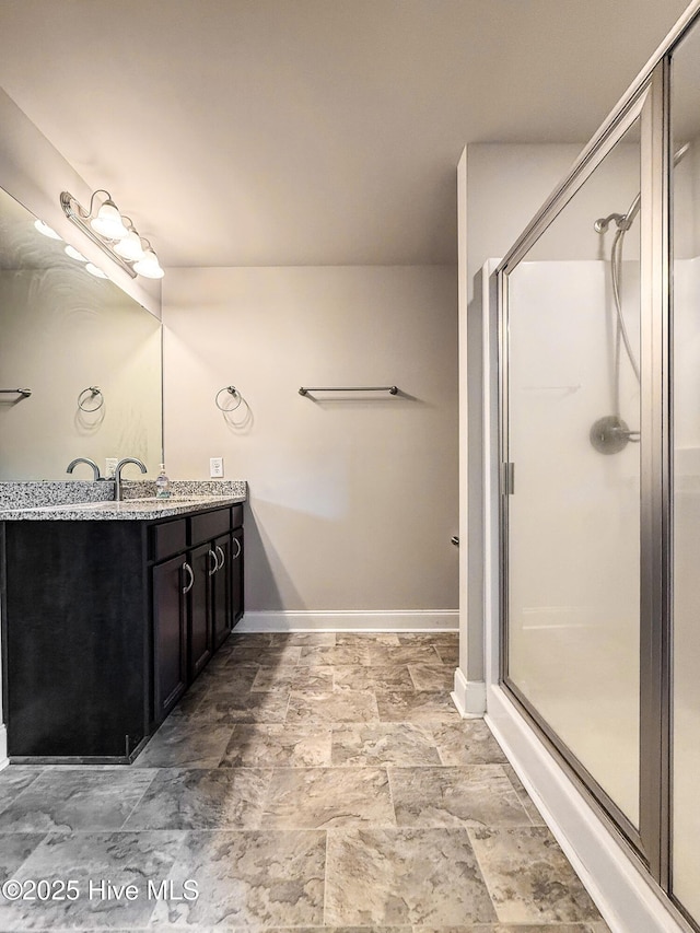 126 Vick Ave, Carthage, NC 28327 - full bath with vanity, a stall shower, baseboards, and stone finish flooring