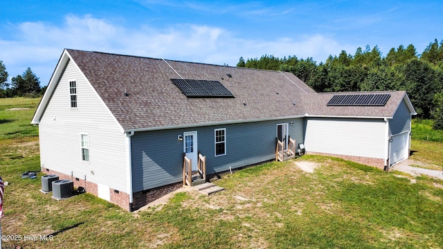 126 Vick Ave, Carthage, NC 28327 - rear view of property featuring roof mounted solar panels, a shingled roof, entry steps, and a yard