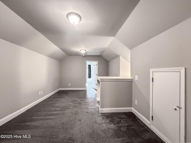 126 Vick Ave, Carthage, NC 28327 - additional living space with dark carpet, lofted ceiling, and baseboards