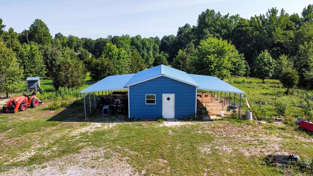 126 Vick Ave, Carthage, NC 28327 - view of outbuilding featuring a carport and a view of trees