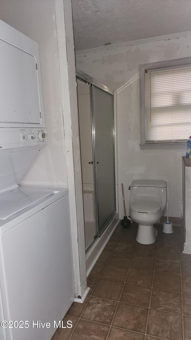 2720 Loop Rd, Loris, SC 29569 - full bath with stacked washer / drying machine, toilet, a stall shower, and tile patterned flooring
