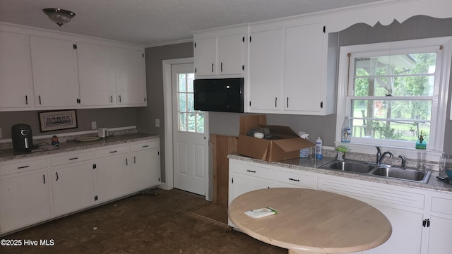2720 Loop Rd, Loris, SC 29569 - kitchen featuring a sink, white cabinets, ornamental molding, and light stone counters