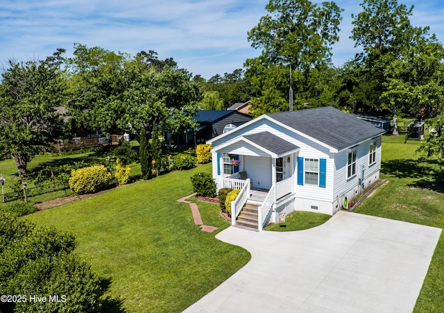 2003 Riverview Ln, Morehead City, NC 28557 - view of front of property with a porch, a shingled roof, driveway, a front lawn, and view of wooded area