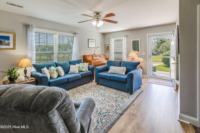 2003 Riverview Ln, Morehead City, NC 28557 - living area with plenty of natural light, light wood finished floors, ceiling fan, and baseboards