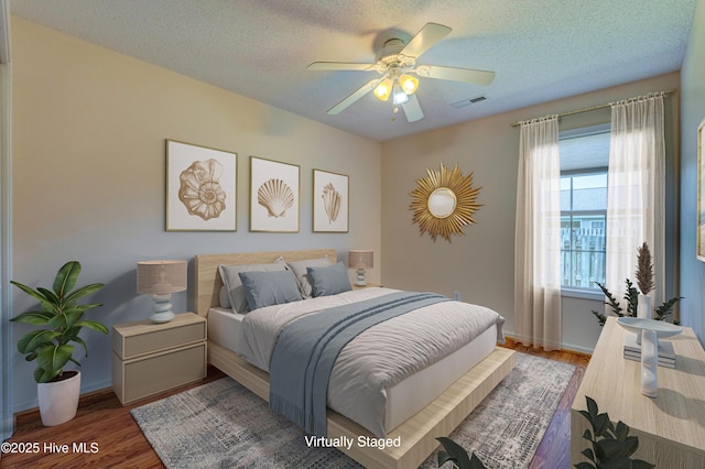 435 Foxfield Ct, Wilmington, NC 28411 - bedroom featuring wood finished floors, baseboards, a ceiling fan, and a textured ceiling