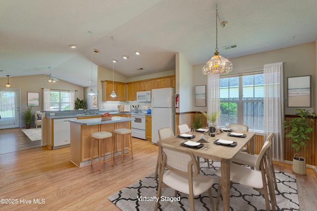 435 Foxfield Ct, Wilmington, NC 28411 - dining room featuring vaulted ceiling, light wood-style floors, a chandelier, and ceiling fan