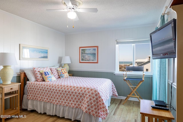 301 E Commerce Way Unit 350, Atlantic Beach, NC 28512 - bedroom featuring wood finished floors, crown molding, and a textured ceiling