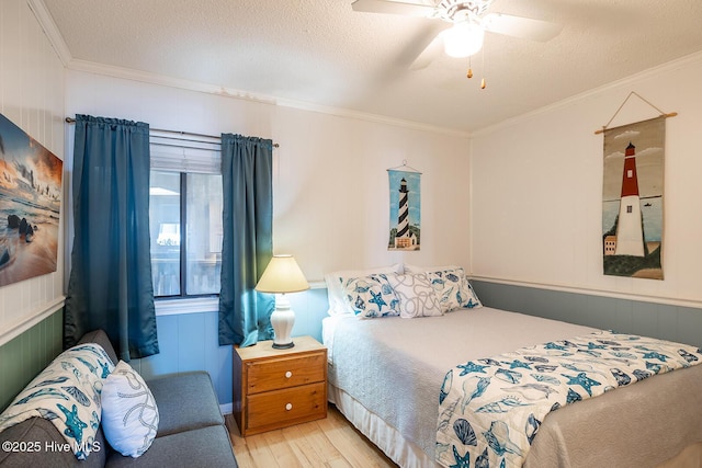 301 E Commerce Way Unit 350, Atlantic Beach, NC 28512 - bedroom with wood finished floors, ornamental molding, a textured ceiling, and a ceiling fan