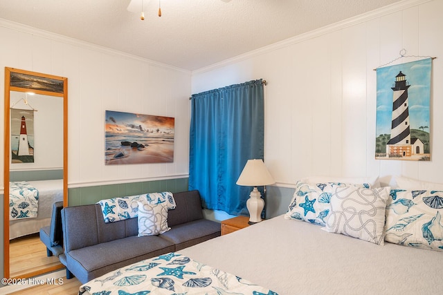 301 E Commerce Way Unit 350, Atlantic Beach, NC 28512 - bedroom featuring crown molding, wood finished floors, and a decorative wall