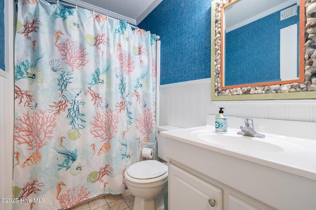 301 E Commerce Way Unit 350, Atlantic Beach, NC 28512 - bathroom featuring ornamental molding, vanity, toilet, a wainscoted wall, and tile patterned floors