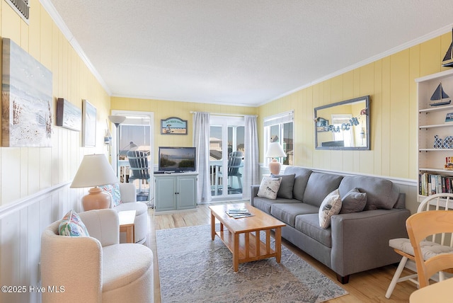 301 E Commerce Way Unit 350, Atlantic Beach, NC 28512 - living room with ornamental molding, healthy amount of natural light, wood finished floors, a textured ceiling, and wood walls