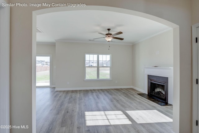 129 Tides End Dr Lot 34, Holly Ridge, NC 28445 - unfurnished living room with light wood-type flooring, healthy amount of natural light, ornamental molding, a fireplace, and a ceiling fan