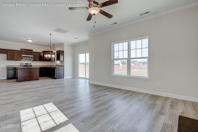 129 Tides End Dr Lot 34, Holly Ridge, NC 28445 - unfurnished living room with ornamental molding, light wood-style floors, a ceiling fan, baseboards, and a chandelier