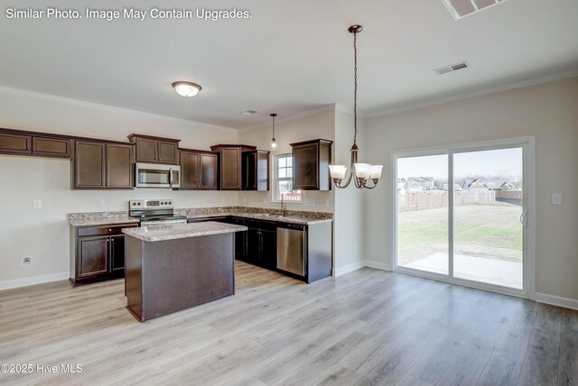 129 Tides End Dr Lot 34, Holly Ridge, NC 28445 - kitchen with stainless steel appliances, a chandelier, dark brown cabinetry, a kitchen island, and light wood-type flooring