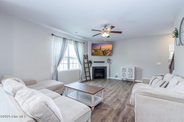106 Featherstone Ln, New Bern, NC 28562 - living room featuring a ceiling fan, wood finished floors, a glass covered fireplace, and baseboards