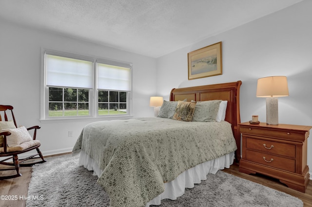 353 Old Savannah Rd, Burgaw, NC 28425 - bedroom featuring wood finished floors, baseboards, and a textured ceiling