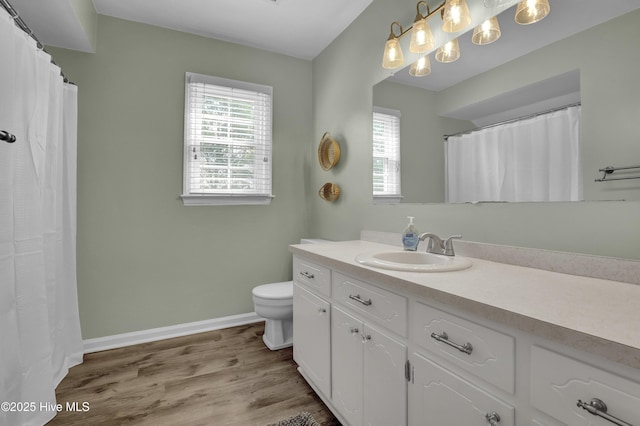 353 Old Savannah Rd, Burgaw, NC 28425 - bathroom with vanity, toilet, wood finished floors, and baseboards