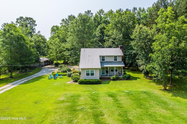 353 Old Savannah Rd, Burgaw, NC 28425 - view of front of home with a porch, a chimney, a front lawn, driveway, and metal roof