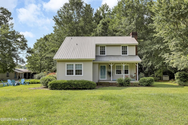 353 Old Savannah Rd, Burgaw, NC 28425 - view of front of property featuring covered porch, a chimney, a front lawn, and metal roof