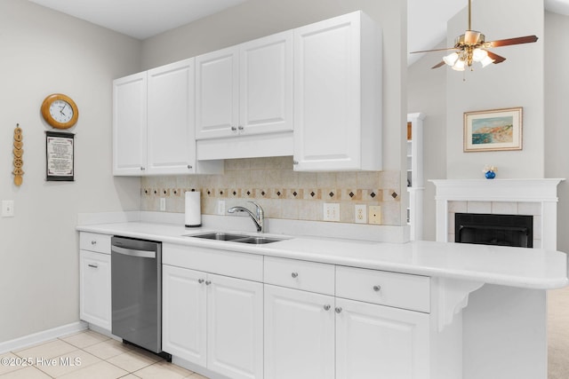 4156 Buckingham Ct, Southport, NC 28461 - kitchen featuring dishwasher, a sink, backsplash, white cabinetry, and light countertops