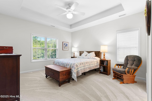 4156 Buckingham Ct, Southport, NC 28461 - bedroom featuring a tray ceiling, light carpet, baseboards, and a ceiling fan