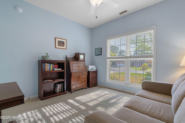 4156 Buckingham Ct, Southport, NC 28461 - living area with light colored carpet, ceiling fan, and baseboards