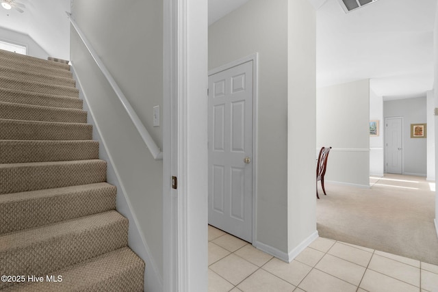 4156 Buckingham Ct, Southport, NC 28461 - staircase with carpet floors, tile patterned flooring, and baseboards