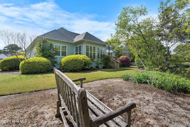 4156 Buckingham Ct, Southport, NC 28461 - rear view of house with a yard and a shingled roof