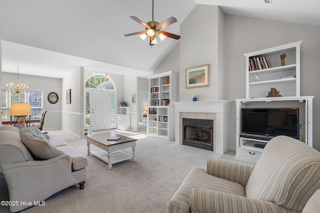 4156 Buckingham Ct, Southport, NC 28461 - carpeted living room featuring high vaulted ceiling, a chandelier, a ceiling fan, and a tile fireplace