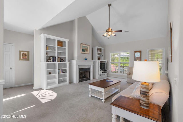4156 Buckingham Ct, Southport, NC 28461 - living room with ceiling fan, high vaulted ceiling, a fireplace, carpet, and baseboards