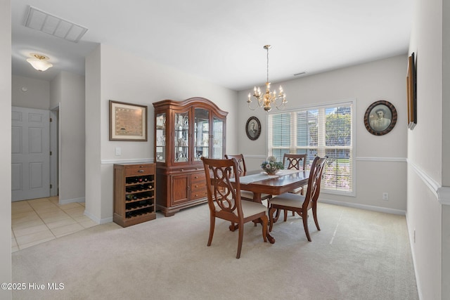 4156 Buckingham Ct, Southport, NC 28461 - dining area featuring light colored carpet, a chandelier, and baseboards