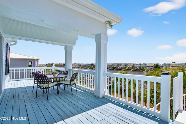 1510 N Shore Dr, Sunset Beach, NC 28468 - wooden terrace featuring a water view, outdoor dining space, and a residential view