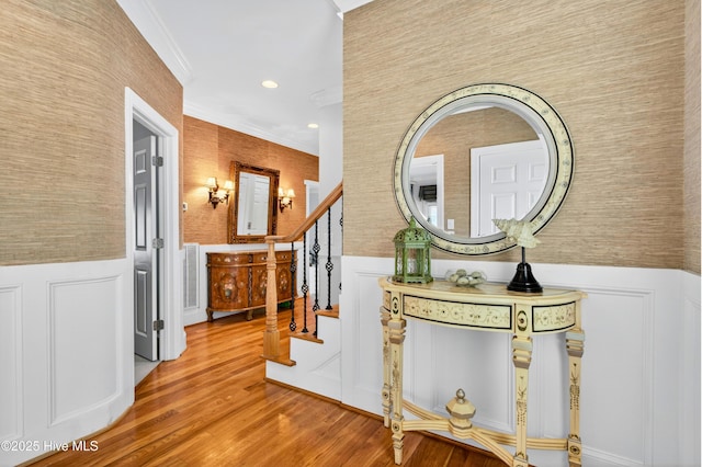 1510 N Shore Dr, Sunset Beach, NC 28468 - hall with a wainscoted wall, crown molding, wood finished floors, a decorative wall, and stairs