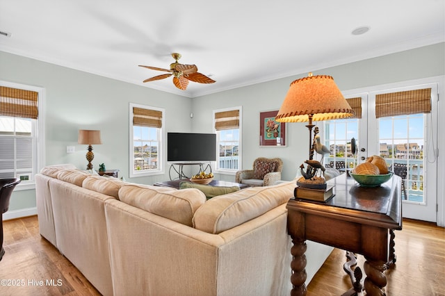 1510 N Shore Dr, Sunset Beach, NC 28468 - living room featuring a ceiling fan, ornamental molding, and light wood-style flooring