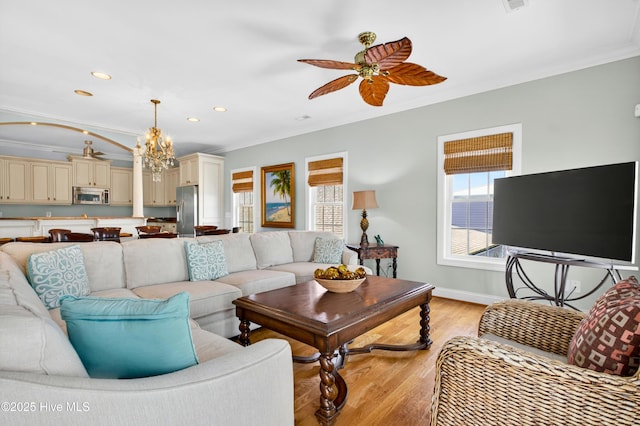 1510 N Shore Dr, Sunset Beach, NC 28468 - living room featuring crown molding, ceiling fan, light wood finished floors, recessed lighting, and a chandelier