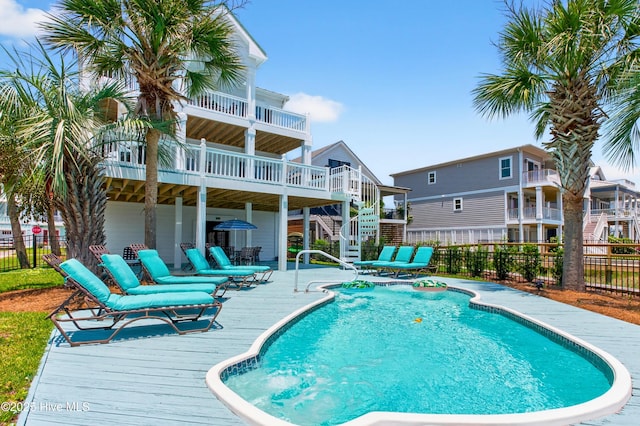 1510 N Shore Dr, Sunset Beach, NC 28468 - view of swimming pool with stairway, a wooden deck, and a patio