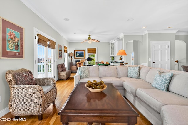 1510 N Shore Dr, Sunset Beach, NC 28468 - living room featuring arched walkways, light wood finished floors, a ceiling fan, crown molding, and recessed lighting