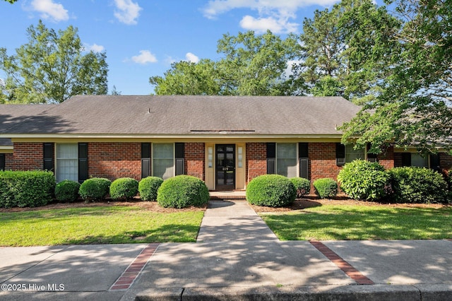 809 Greenbriar Rd, Kinston, NC 28501 - single story home with brick siding, a front yard, and a shingled roof